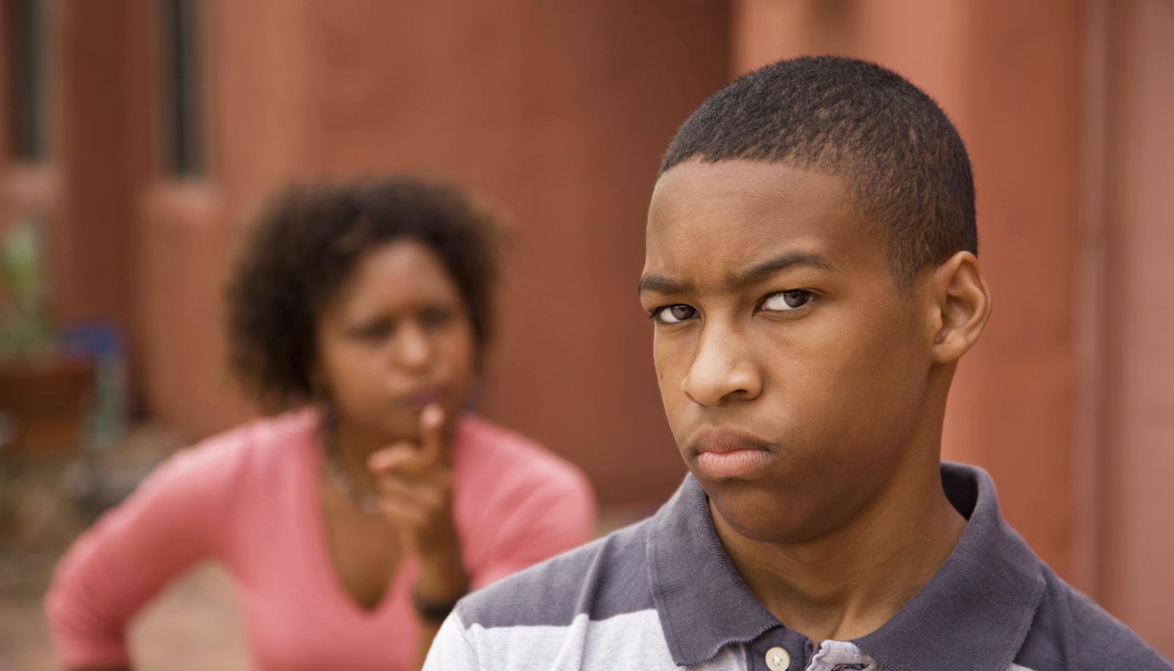 Upset teen and mother outside of house
