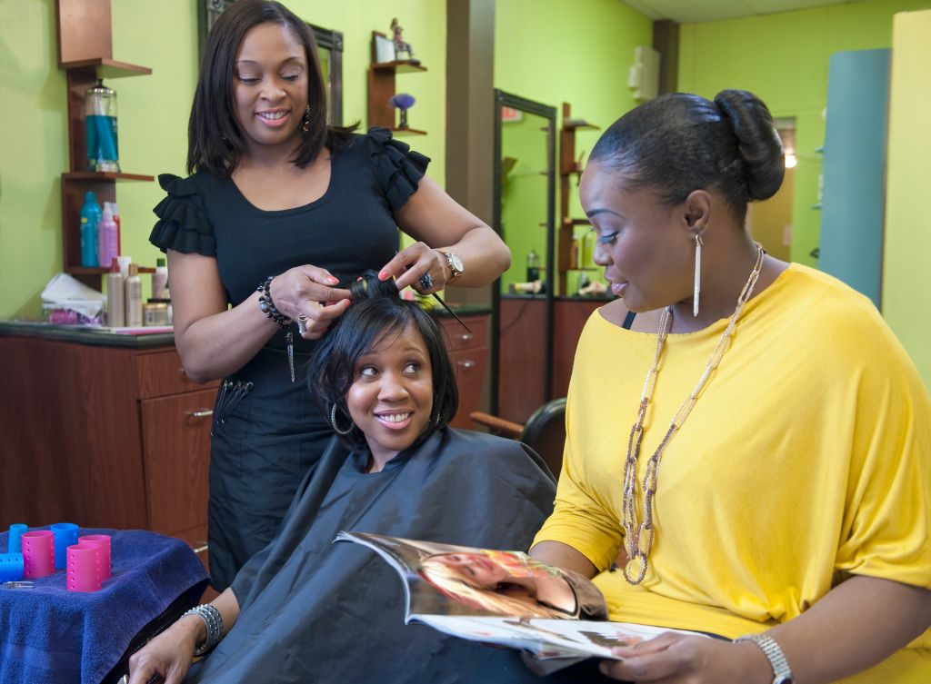 Woman with friend getting hair done at salon