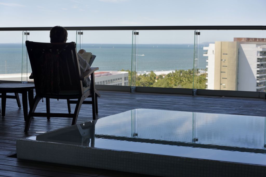 Tourist reading a book on the balcony of the penthouse suite Vidanta Nuevo Vallarta Mexico