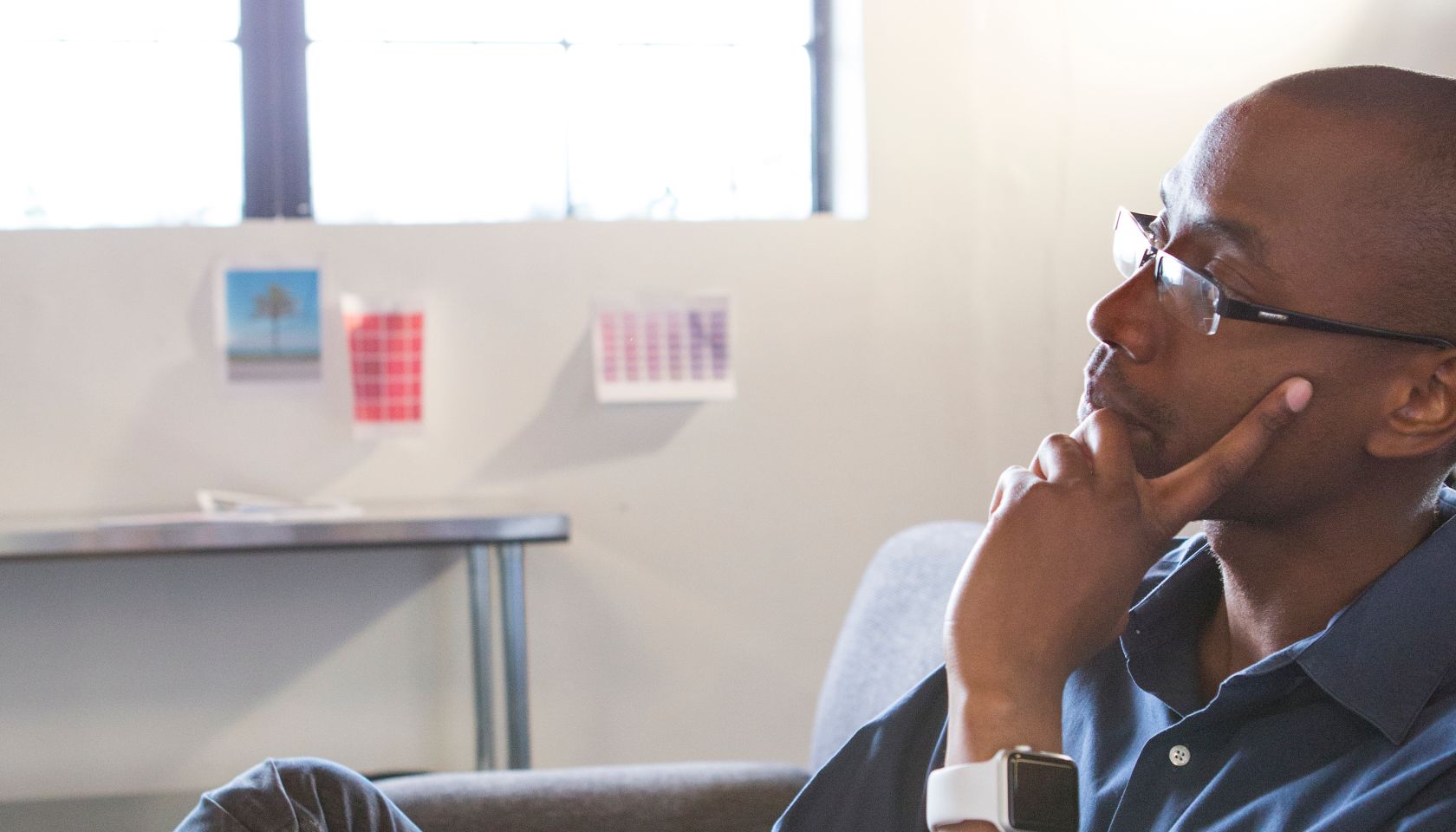Mixed race businessman thinking in office