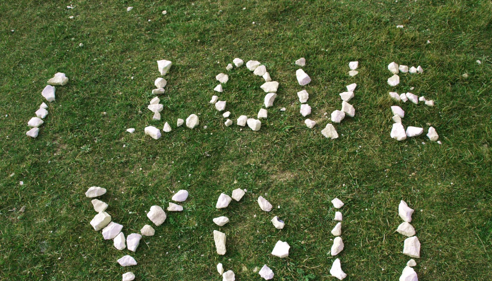 High Angle View Of I Love You Text Made From White Stones On Field
