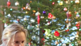 Online Christmas shopping: woman besides xmas tree