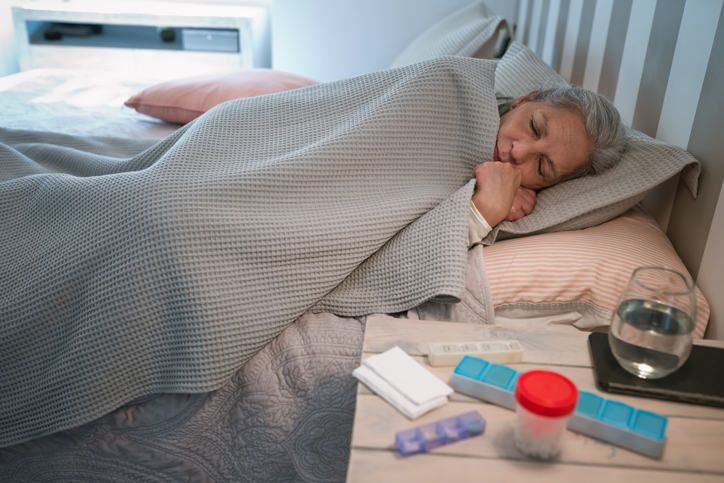 Sick senior woman sleeping in bed