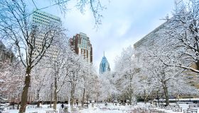 Rittenhouse Square after a snow storm surrouned by city skyline Philadelphia