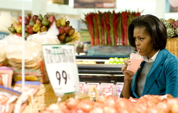 US First Lady Michelle Obama drinks a st