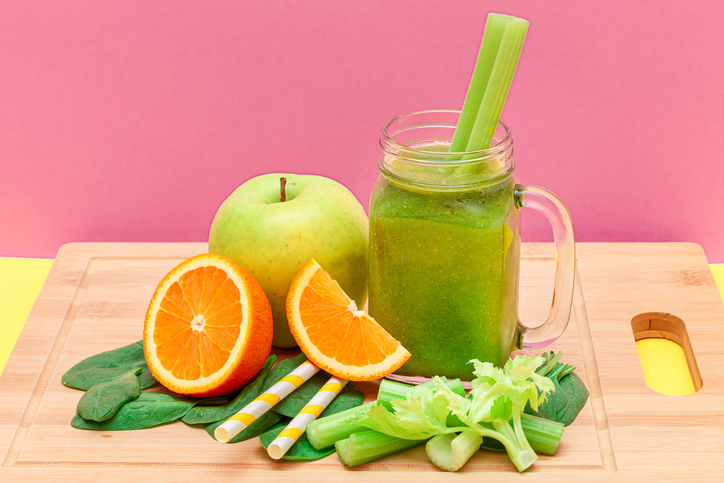 Fresh Green Smoothie of Apple, Celery, Spinach and Orange in Glass Smoothie Jar