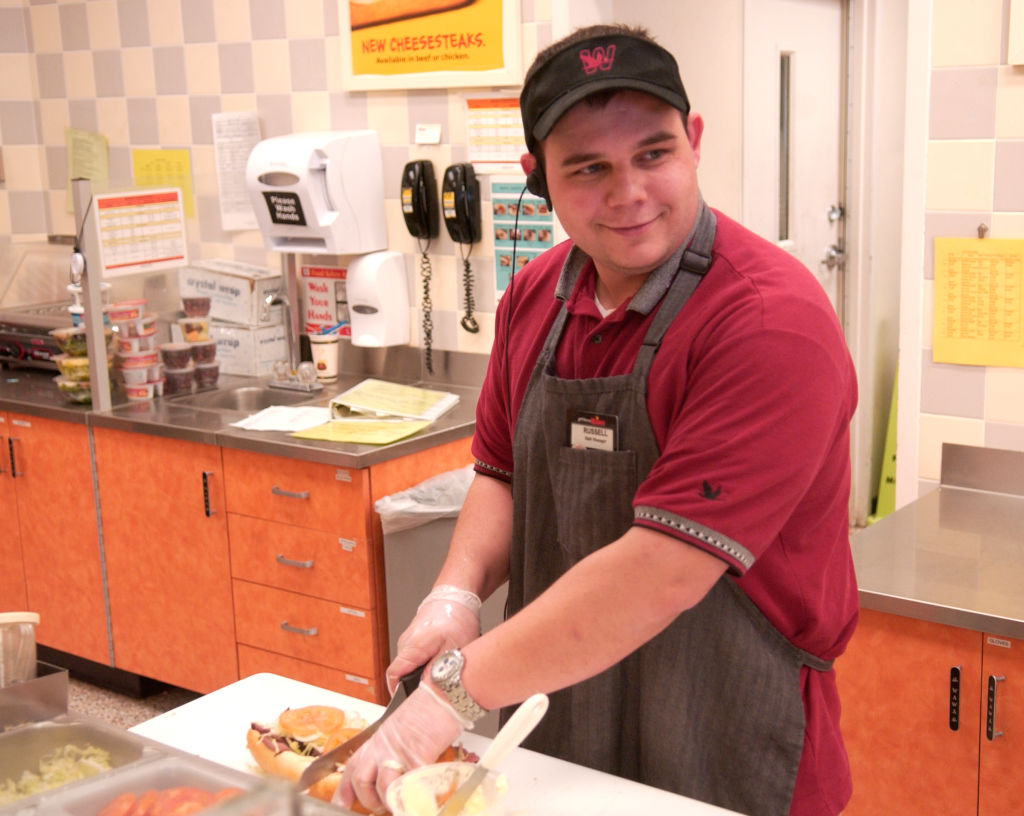 2/26/07 photo Ryan McFadden 200700438 Business: Companies open 100yrs or more, Wawa; Russ Humes, a shift manager from shillington works in the deli.