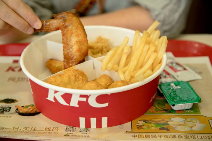KFC food box filled with fried chicken and chips. Since...