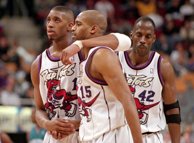 Tracy McGrady (L) consoles Vince Carter after Carter fouled out against the Charlotte Hornets April
