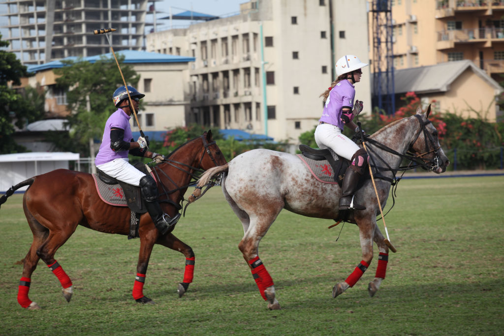 Polo players compete for the ball during the Ladies Polo invitation tournament between Team White vs Team Purple, at the Lagos polo club, Ikoyi, Lagos, Nigeria