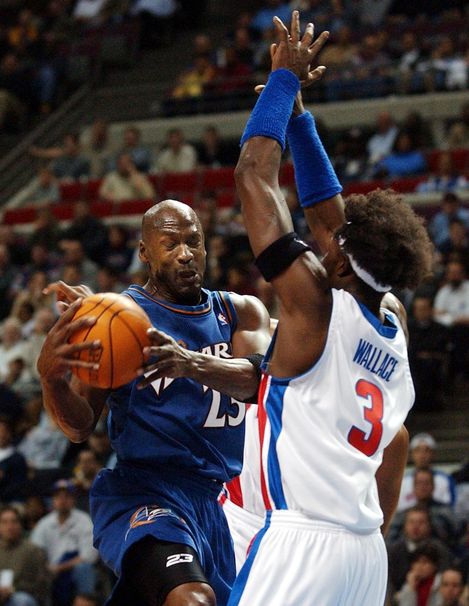 Washington Wizards' Michael Jordan (L) collides wi