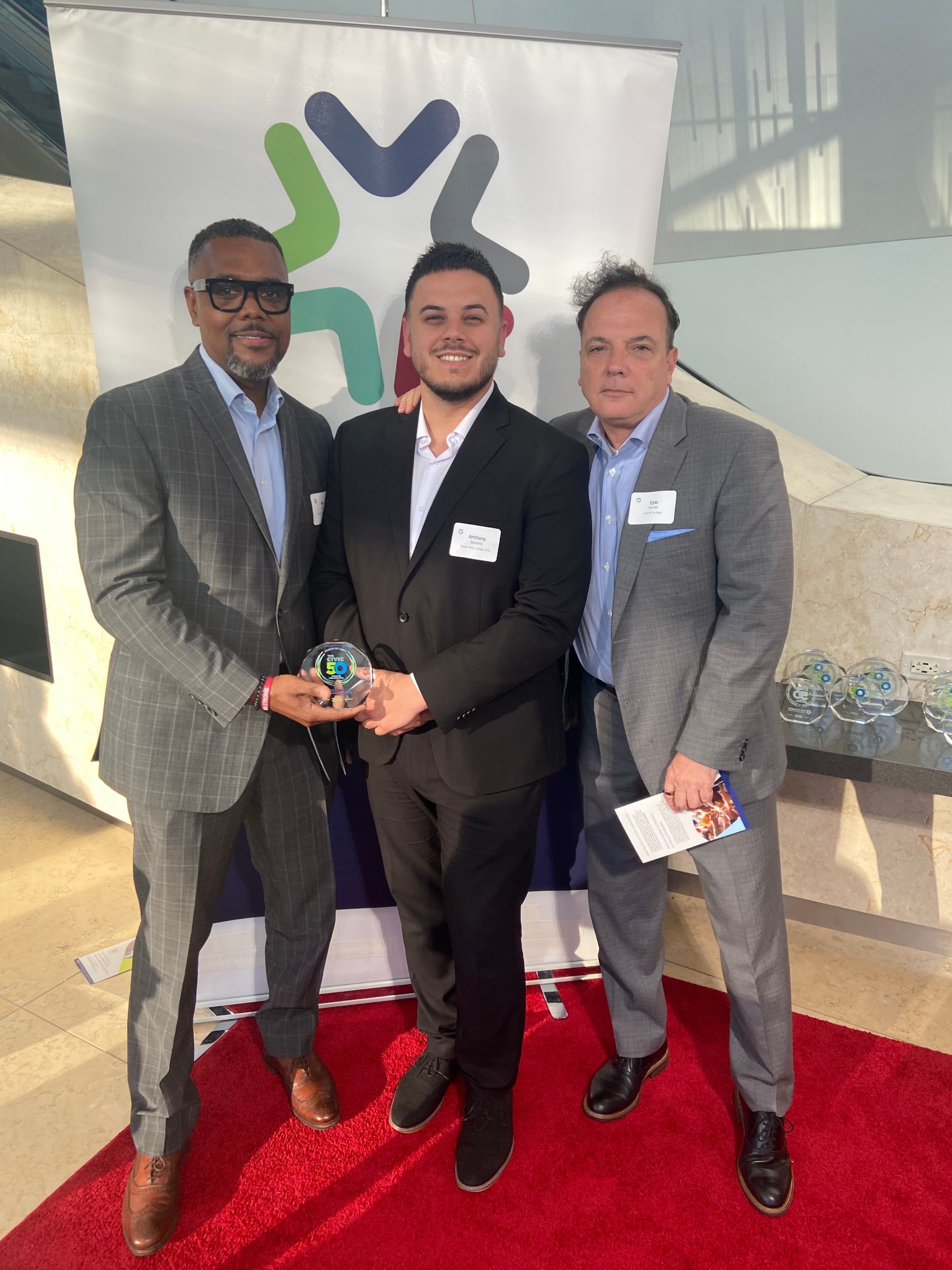 Urban One Philadelphia is awarded the Civic 50 Award accepted by Ezio Torres, Sean Sams, and Anthony Sellers