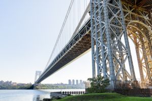 Steel road bridge over a large river on a clear autumn day