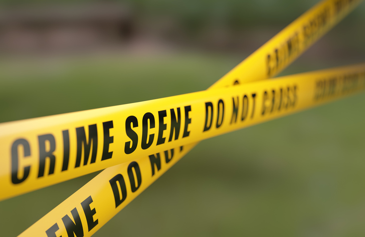 Crime Scene Tape Barrier In Front Of Defocused Background