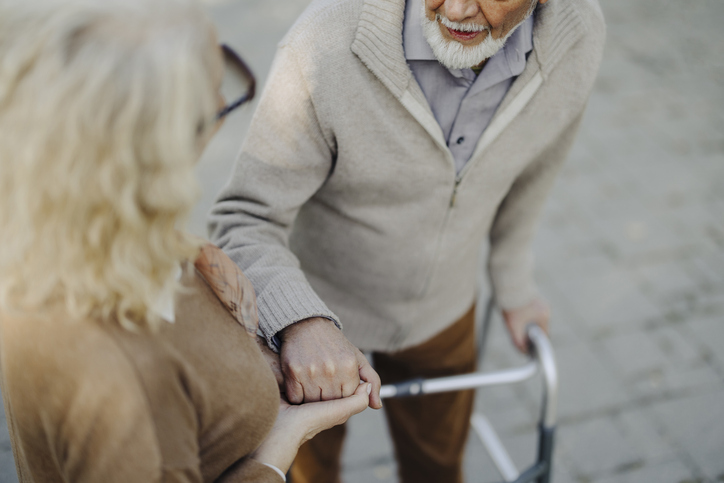 Elderly Couple Enjoys a Leisurely Walk in the Park