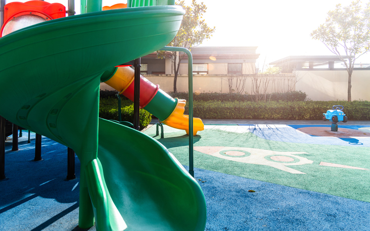 A colorful playground with tipped slides in the park