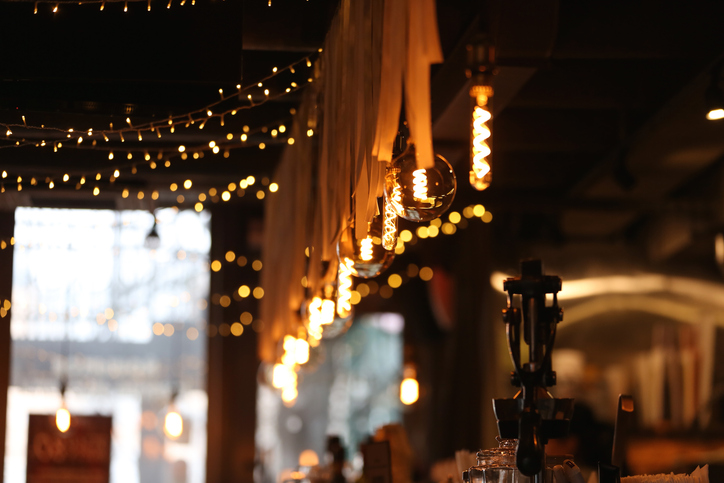 Warm And Cozy Interior Small Local Bar Counter With Handmade Lights, Christmas Garlands And Elegant Decorative Details