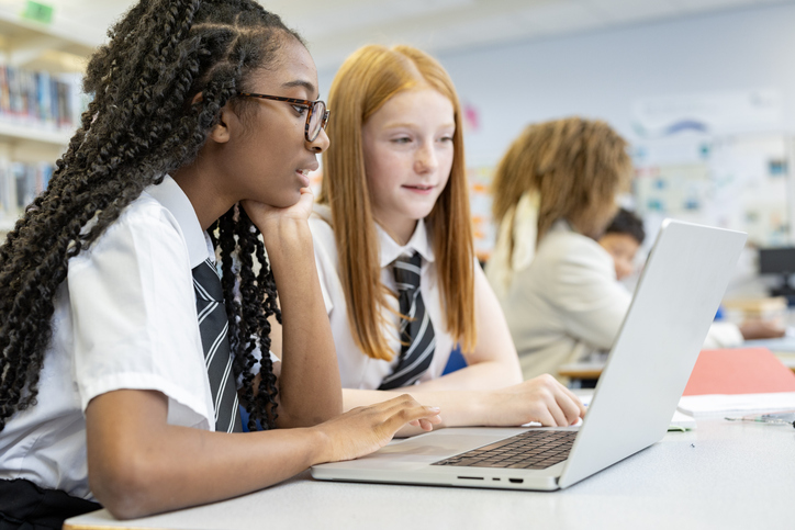 Teenage high school students studying in the school library