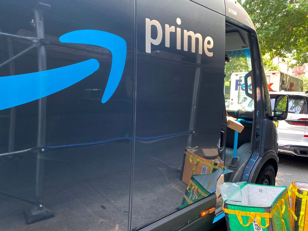 Amazon Prime delivery van with employee unloading packages from truck, Queens, New York