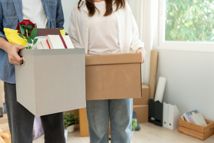 Moving house, relocation. Couples hold carton box contain equipment for new condominium, inside the room was a cardboard box containing personal belongings and furniture. move in the apartment