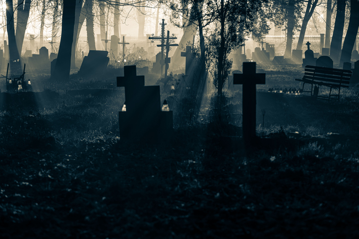 Misty Cemetery with Silhouetted Crosses