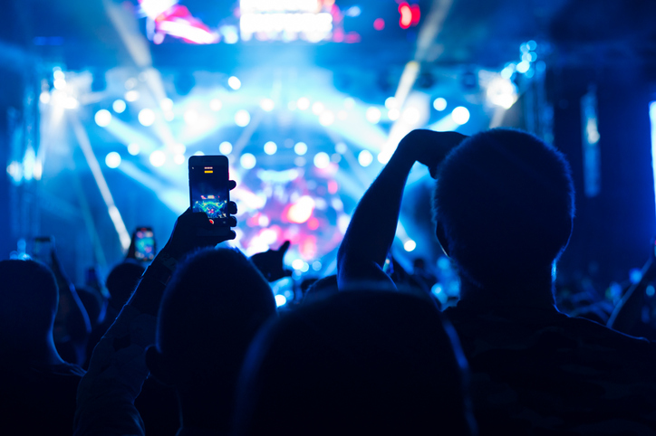 Audience cheering on the concert at summer night