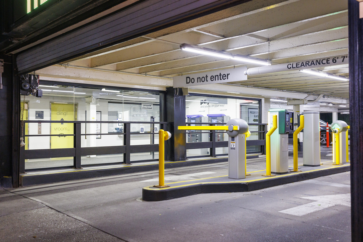 Closed barrier gate at the entrance of an automated parking garage at night in New York City.