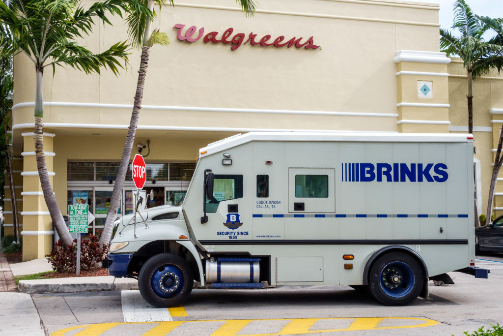 A Brinks armored truck parked in front of Walgreens.