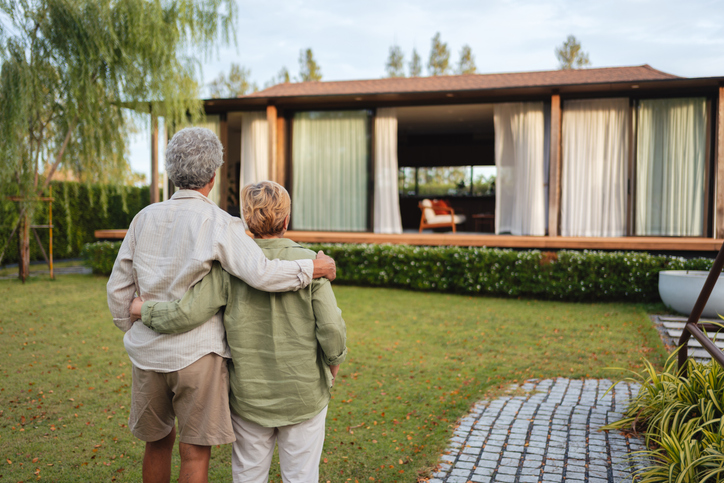 Senior couple looking at a modern home