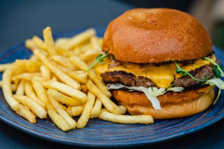 A juicy beef hamburger layered with melted cheese, fresh lettuce, and ketchup
