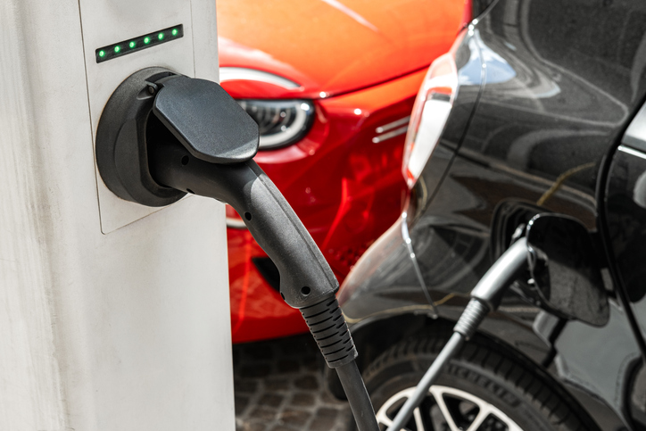 Electric Car Charging at Urban Station With Plug Connected to EV Charging Point