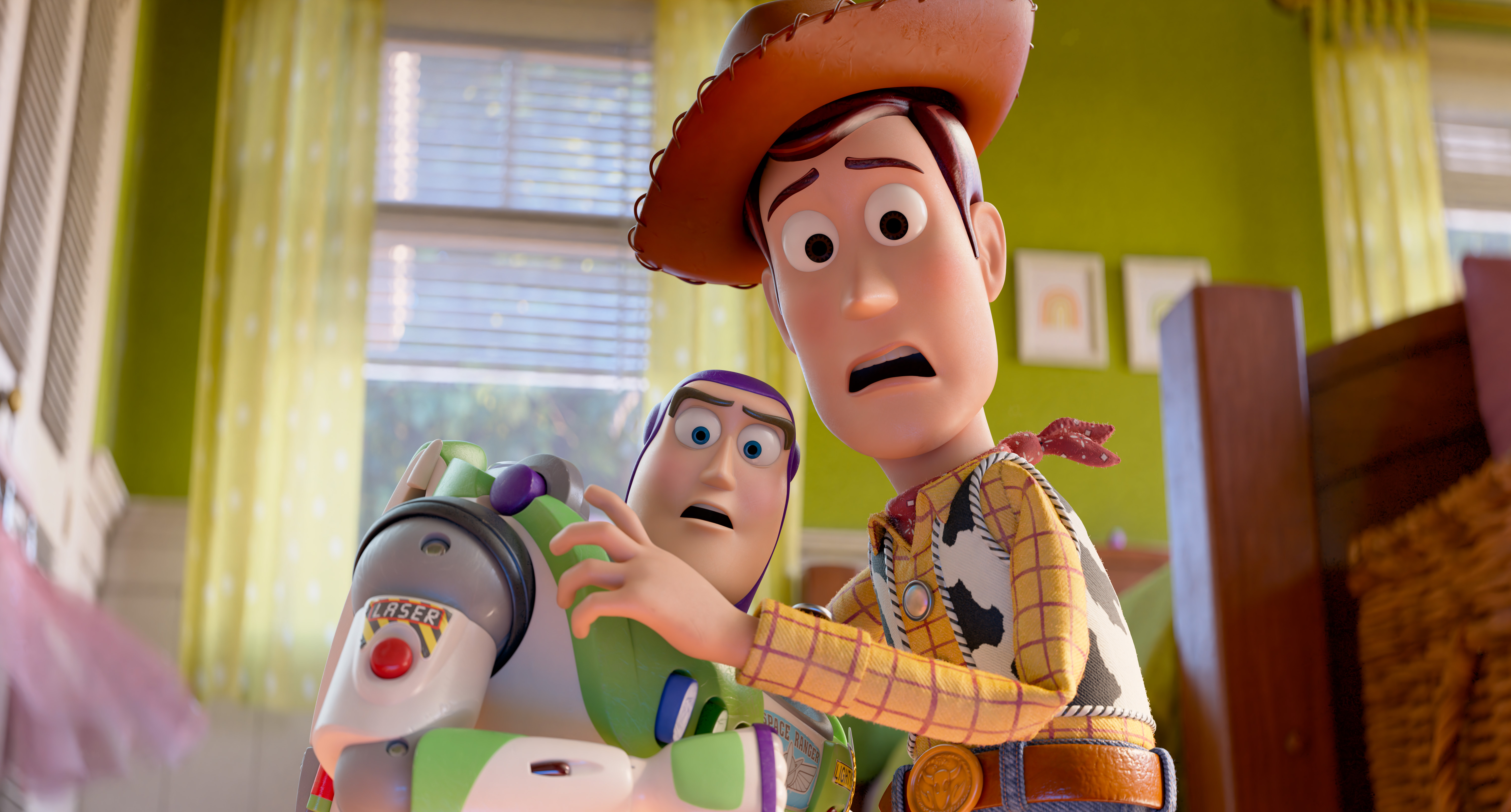 Two animated characters, Buzz Lightyear and Woody, with surprised expressions on their faces in a colorful room.