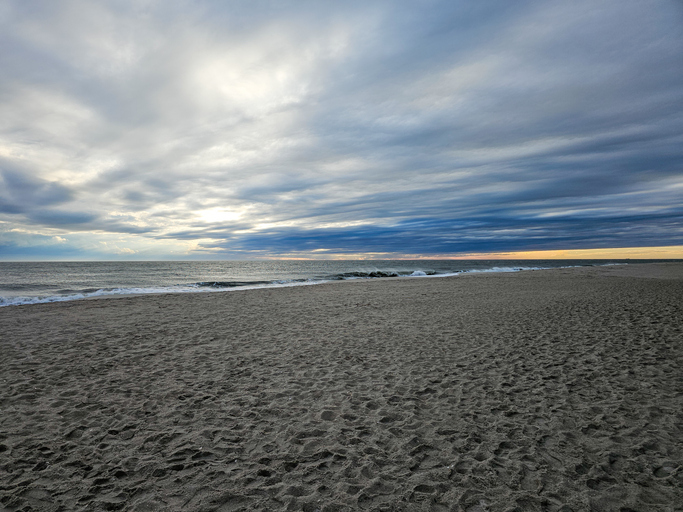 Dramatic cloudy sky over a vast sandy beach and ocean at dusk or dawn,United States,USA,Cape May County