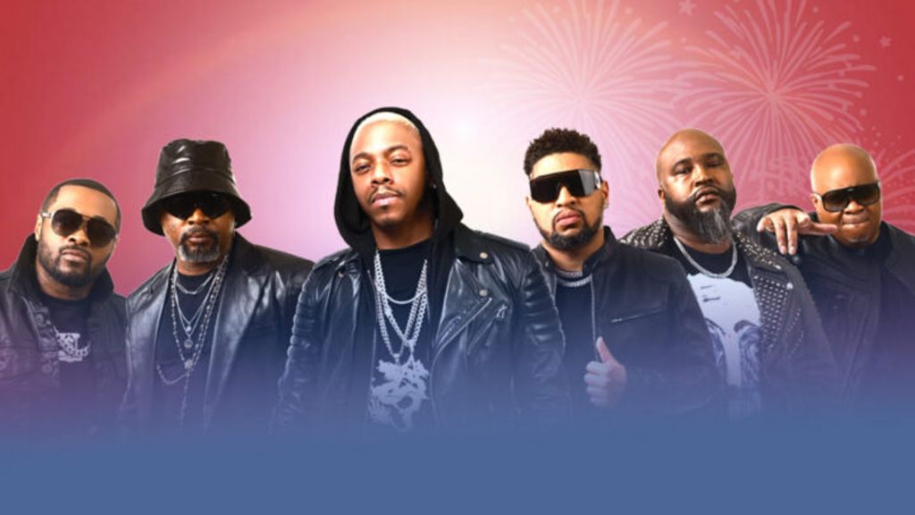 A group of five men wearing sunglasses and leather jackets standing in front of a red background with fireworks.