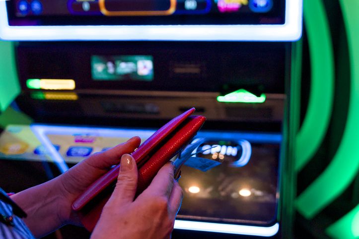 Hands holding phone near slot machine Las Vegas USA November 25 2025