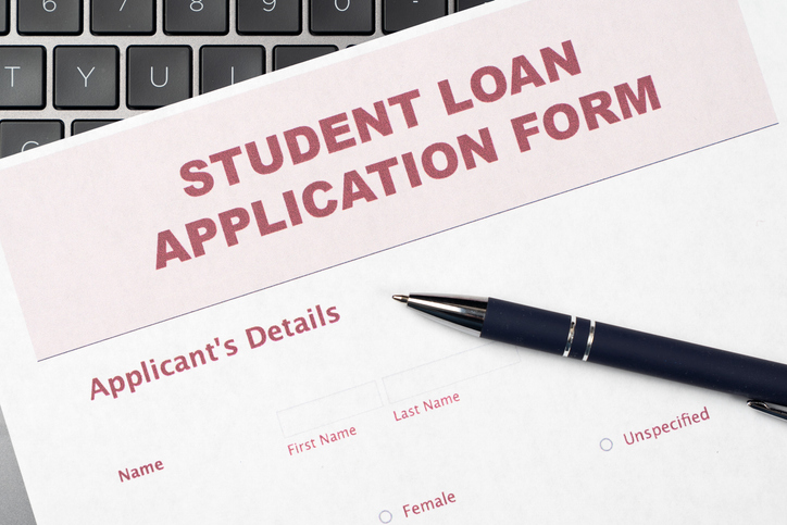 Student Loan Application Form on Laptop Keyboard