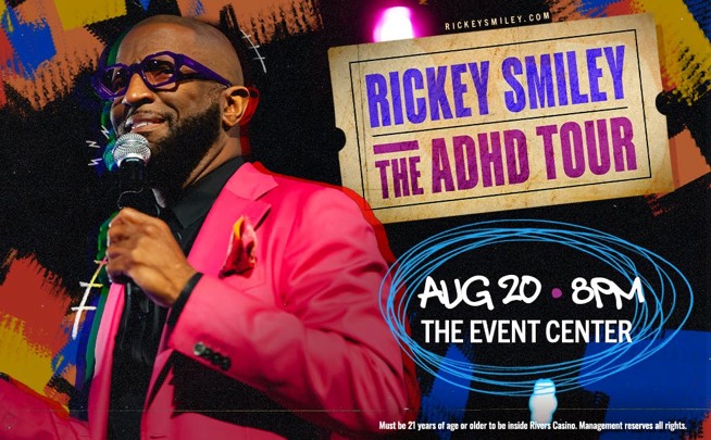 A man wearing a bright pink jacket and glasses speaking into a microphone on stage, with a banner behind him that says "RICKEY SMILEY THE ADHD TOUR" and "THE EVENT CENTER" displayed.